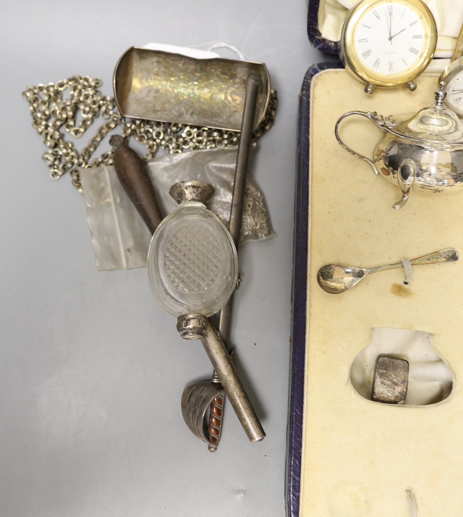 Sundry small silver including a cased part condiment set, three modern silver mounted desk timepieces and a Georgian vinaigrette and thirteen other items including pewter flatware etc.